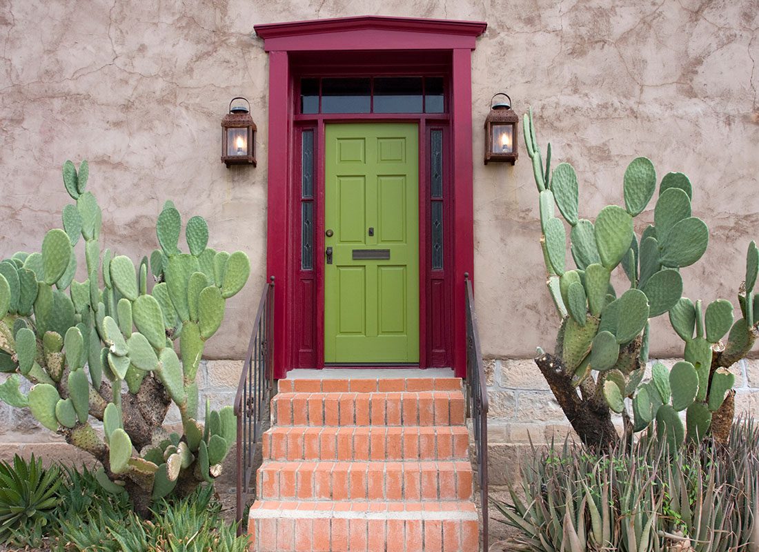 Home Insurance - Closeup View of the Front Door of a Home in Arizona with Two Hanging Lanterns and Cactus Plants in the Front