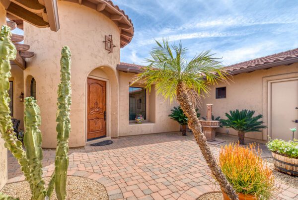 Personal Insurance - Exterior View of a Spanish Style Stucco Single Story Home with Pavers and Decorative Plants in Arizona